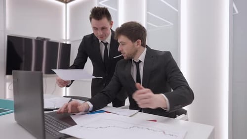 Dois analistas profissionais caucasianos positivos falando, sorrindo, virando para a câmera