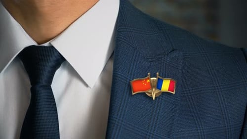 Close up of China and Romania Flag Pin on Suit