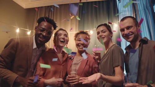 Friends Toasting with Champagne as Confetti Falls
