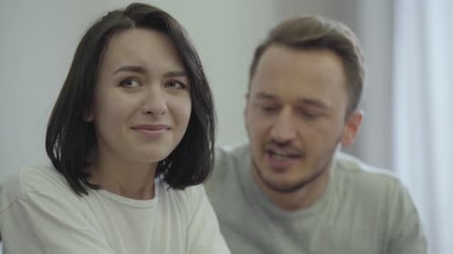 Upset Woman Crying While Man Comforts Her