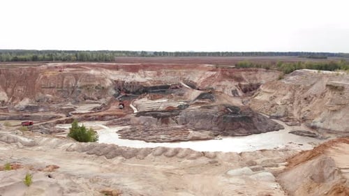 Cantera gigante con extracción de minerales. Zumbido que sobrevuela una cantera de arena o arcilla con maquinaria pesada