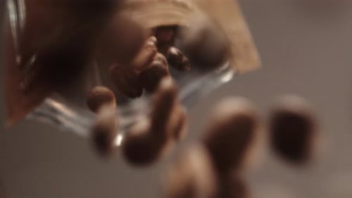 Roasted Coffee Beans Pouring from Brown Bag