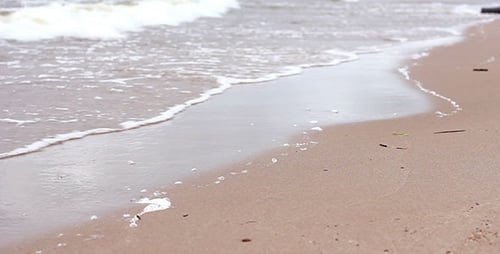 Gentle Ocean Waves Rolling onto Sandy Beach