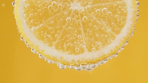 Refreshing Lemon Slice in Sparkling Water, Close-Up