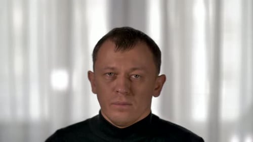 Man Wearing Black Turtleneck Stares Forward