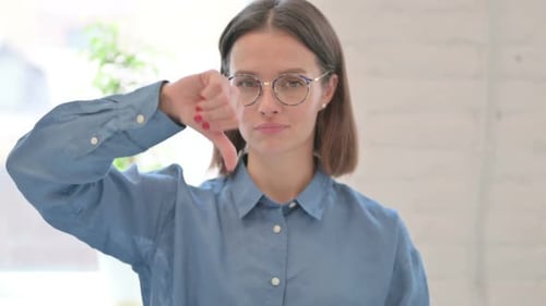 Woman Gives Thumbs Down Gesture Indoors