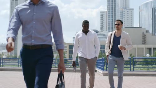 Young Business People Walking Outdoor along City Street