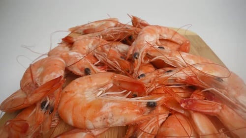 Pile of Fresh Shrimp on Wooden Board