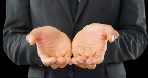 Adult in Suit Holding Open Palms Outward
