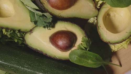 Vegetables and Herbs with Sliced Avocados on Cutting Board