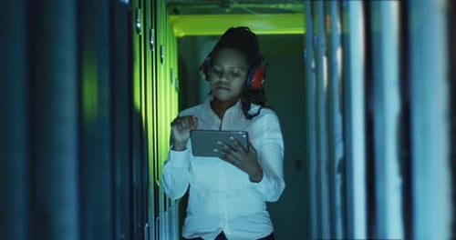 Woman Working with Tablet in Server Room