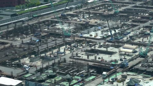 Large Construction Site with Heavy Construction Machinery in Metropolis