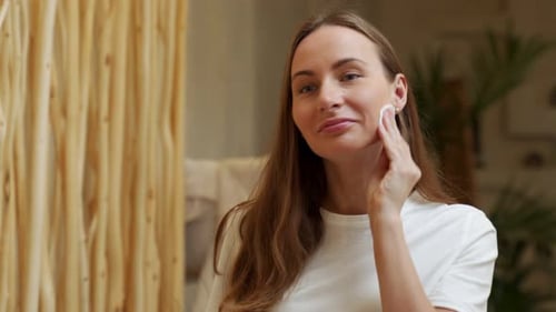 Woman Removing Makeup With Cotton Pad