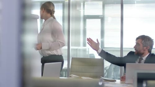 Businesswoman Giving Presentation to Colleagues in Bright Office