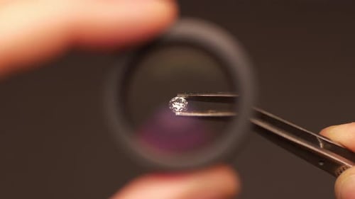 Close-Up of Gemstone Held in Tweezers Under Magnification