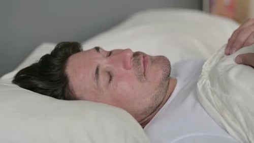 Peaceful Middle Aged Man Sleeping in Bed