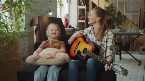 Mother and Daughter Playing Guitar and Singing
