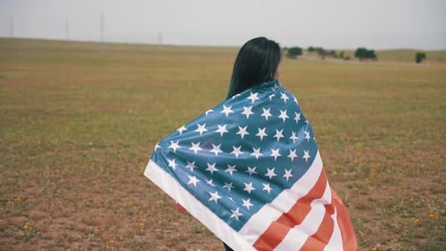 Happy Woman Posing with American Flag in Open Field