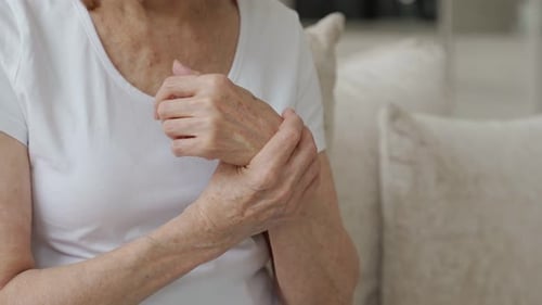 Senior Woman Massaging Wrist for Pain Relief