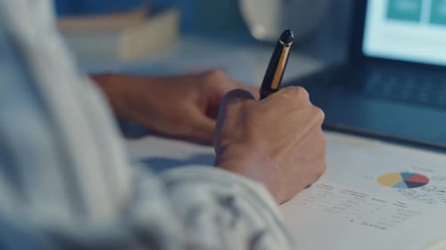 young asia lady freelance focus on laptop write worksheet finance graph account chart market plan.