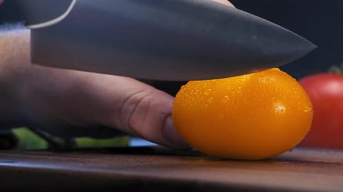 Cutting a Yellow Tomato with a Knife
