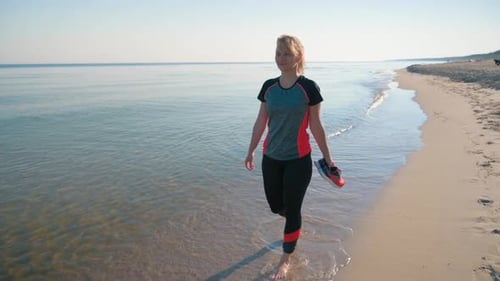 Barefoot Woman Walking on Beach