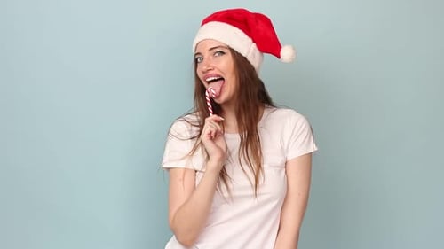 Woman with Candy Cane Wearing Santa Hat