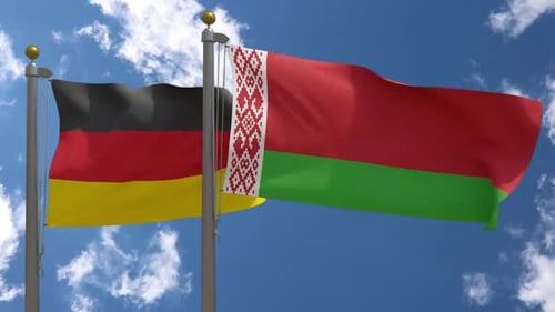 Flags of Germany and Belarus Waving Against Blue Sky