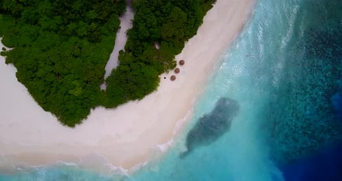 Daytime drone abstract shot of a paradise sunny white sand beach and blue ocean background in 4K