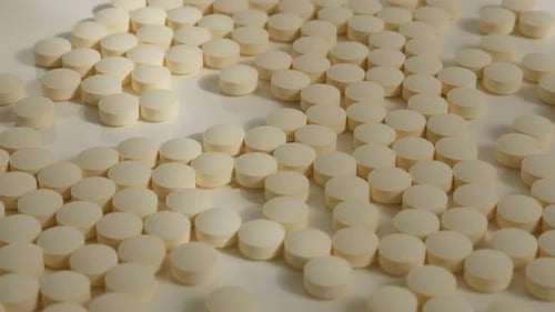 Scattered Beige Pills Close Up