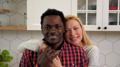 Smiling Couple Embracing in Modern Kitchen