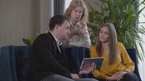 Business Colleagues Discussing Data on Tablet Device