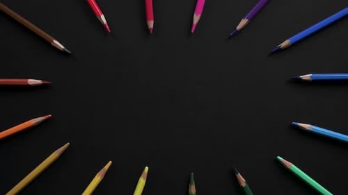 Wooden School Pencils of Different Colors Are Located on the Black Surface. Stop Motion Animation