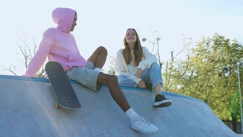 Young Adults Relaxing at the Skatepark Together