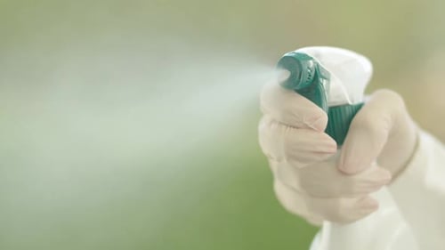 Hand Sanitizing with Spray Bottle in Close Up