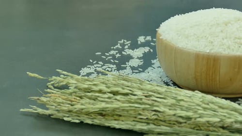 White Rice in Wooden Bowl with Rice Stalks