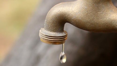Water Dripping From a Metallic Faucet Close Up