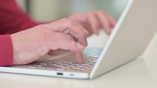 Hands Typing on a Laptop Keyboard Close Up