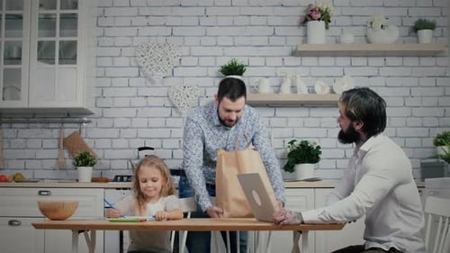 Man enters a room with food bag in his hands