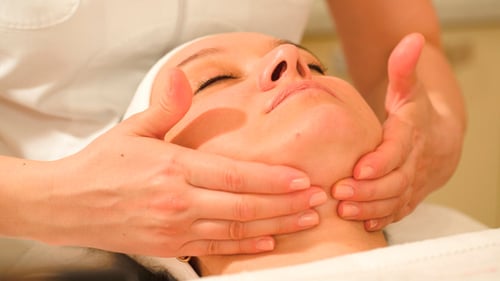 Woman Taking Facial Treatments At Beauty Spa