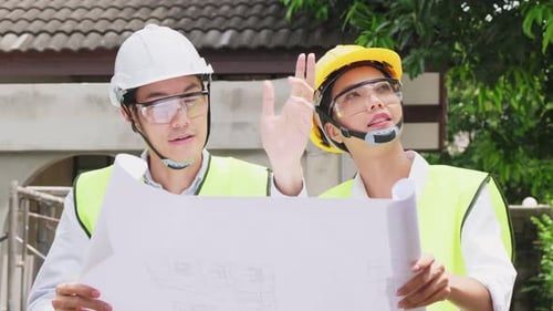 Asian colleague workers people wear protective safety helmet and glasses work in construction site.