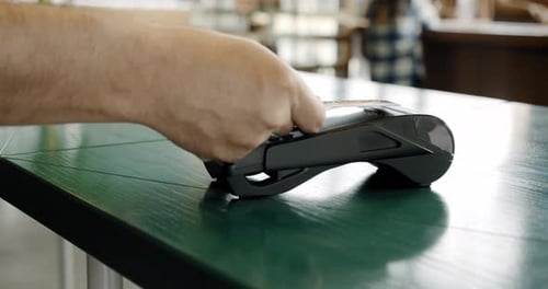 Making Contactless Payment for Using Paying By Credit Card NFC Technology in Coffee Shop, Close Up