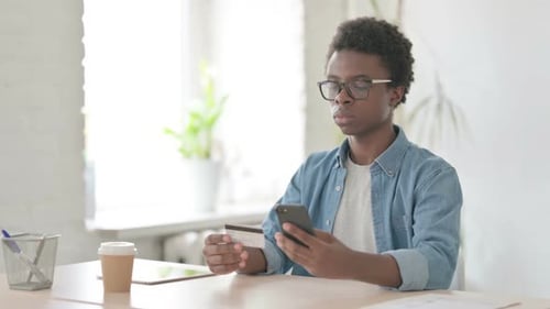 Young Adult Uses Smartphone to Shop Online