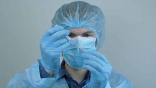 Medical Professional Preparing Syringe Close Up