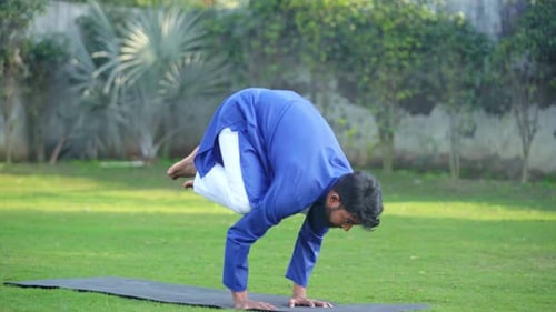 Man Practicing Advanced Crow Pose Yoga Outdoors