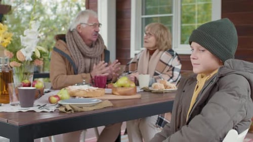Kid with Grandparents Dining on Terrace