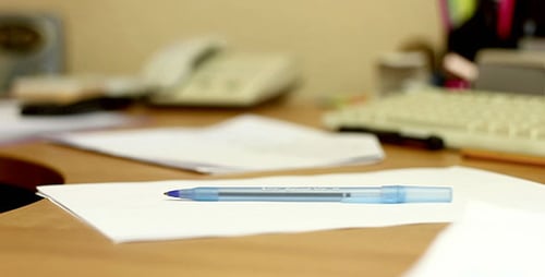 Pen And Paper On Office Desk