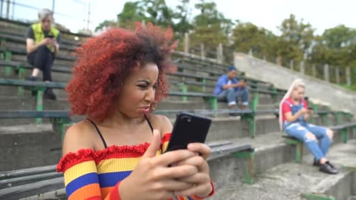 Young Adult Reacting to Phone in an Urban Setting