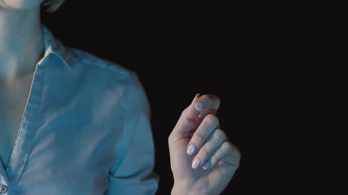 Woman Touches Digital Display at Night