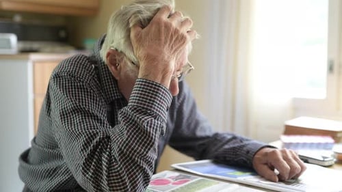 Senior Man Looking Stressed at Table